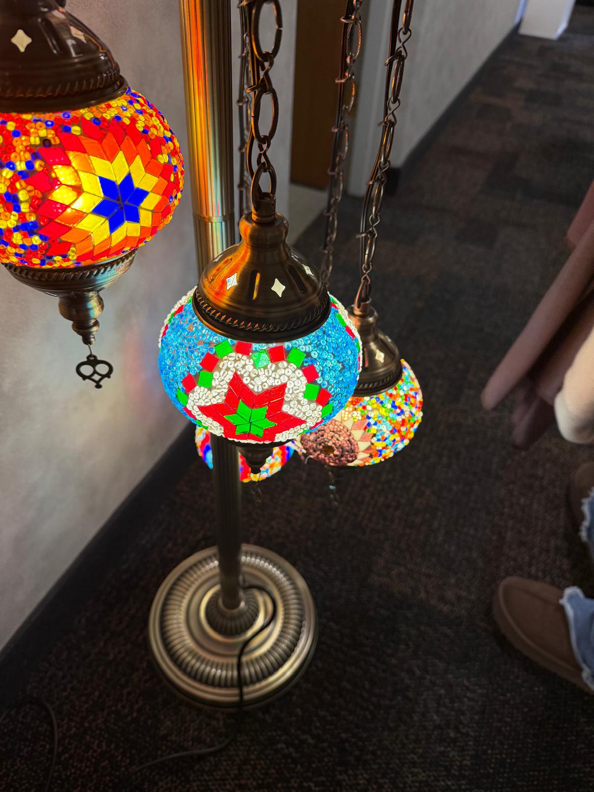 Trio of mosaic globes lit at night